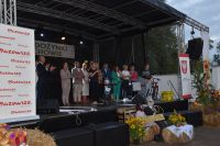 Na zdjęciu scena dożynek w Osuchowie z organizatorami, po bokach banery Urzędu Marszałkowskiego Województwa Mazowieckiego.