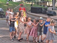 Dzieci idą "gęsiego" podczas zabaw animacyjnych w Amfiteatrze, w trakcie przedstawienia.