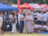 Uczestnicy Odpustu, w tle stoiska lokalnych organizacji, kół, jednostek, przedsiębiorców, szkół.